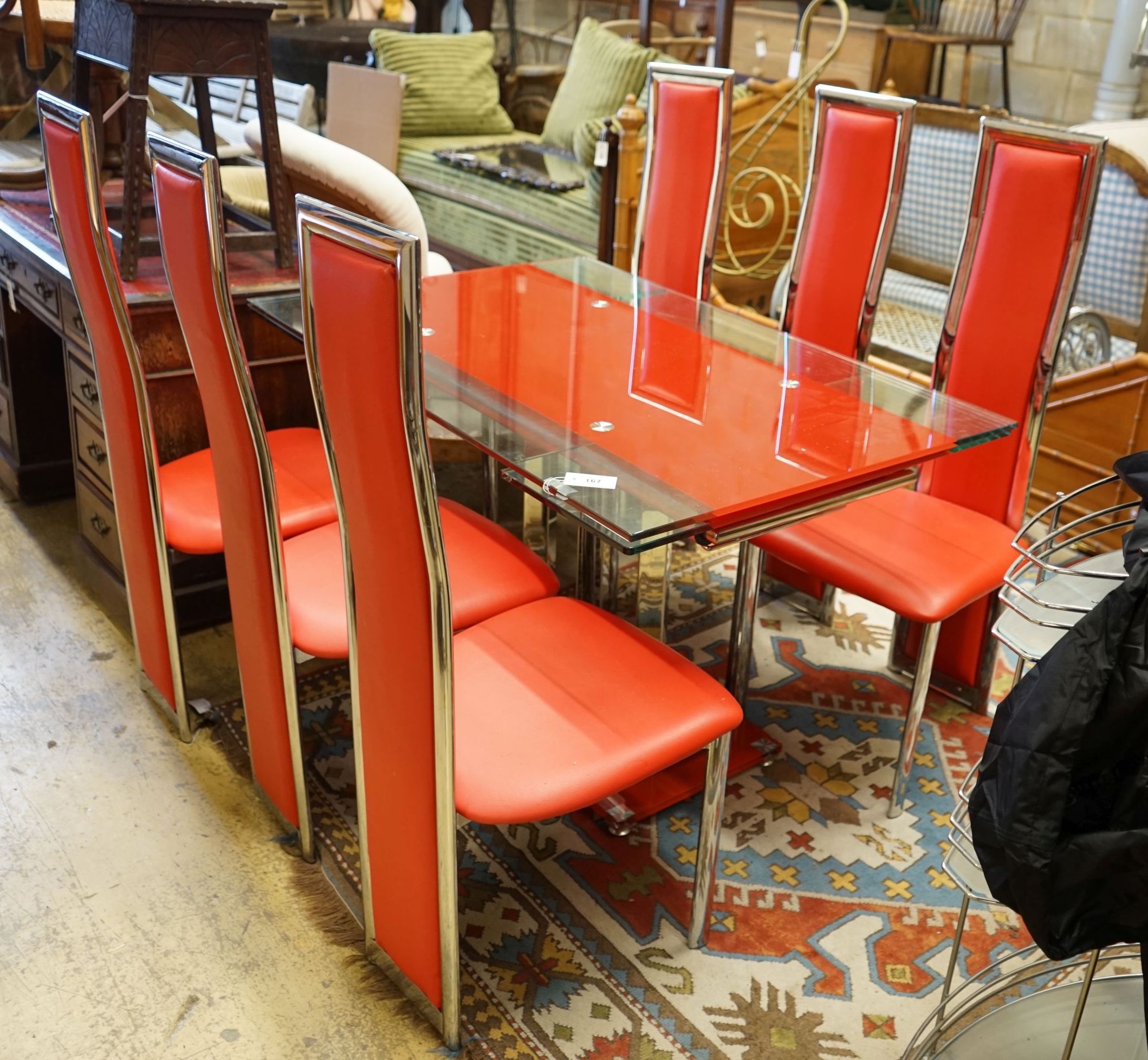 A set of red Italian design dining chairs and an associated chrome table, width unextended 120cm depth 80cm height 75cm